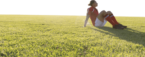 Transparent background rugby player resting on field in afternoon light