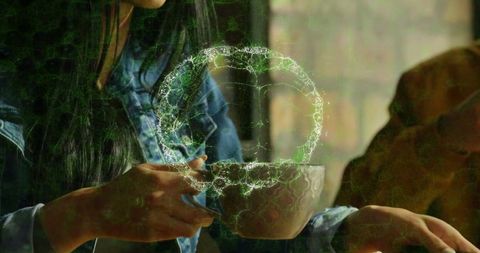 Woman enjoying coffee with digital swirls in cozy cafe setting