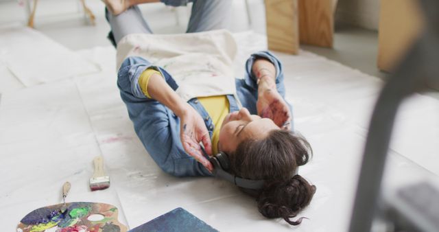 Artist Relaxing on Floor with Headphones - Download Free Stock Images Pikwizard.com