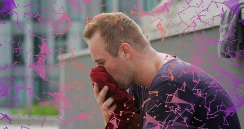 Stressed man pressing shirt to face on concrete ledge with purple geometric overlay