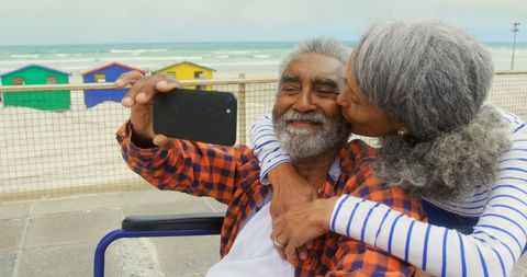 Senior Couple Taking Selfie by the Beach on Romantic Day Out