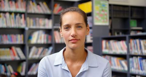 Confident Teacher Posing in School Library - Download Free Stock Images Pikwizard.com