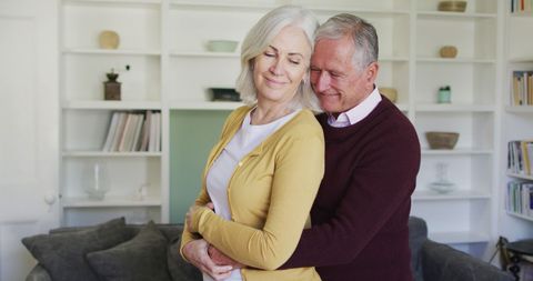 Senior Couple Embracing in Cozy Living Room - Download Free Stock Images Pikwizard.com
