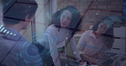 Diverse team collaborating over augmented analytics display in modern office