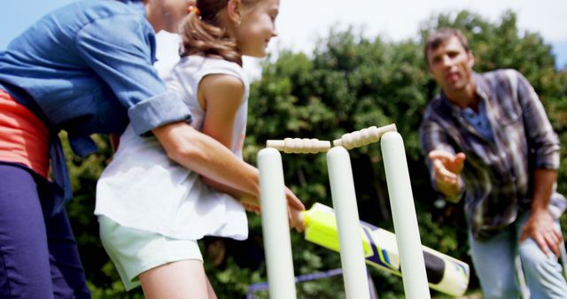 Family Teaching Child to Play Cricket in Garden - Download Free Stock Images Pikwizard.com