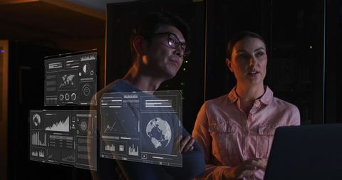 Technicians Analyzing Data Visualization in Server Room