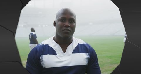 Determined Rugby Players Standing at Foggy Stadium