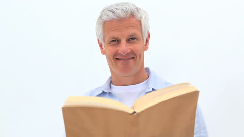 Older Man Joyfully Engaging with Book in Tranquil Setting