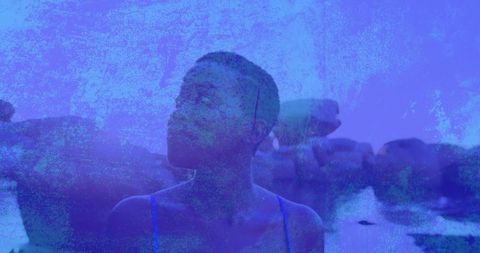 Contemplative woman in blue swimsuit in serene waterscape