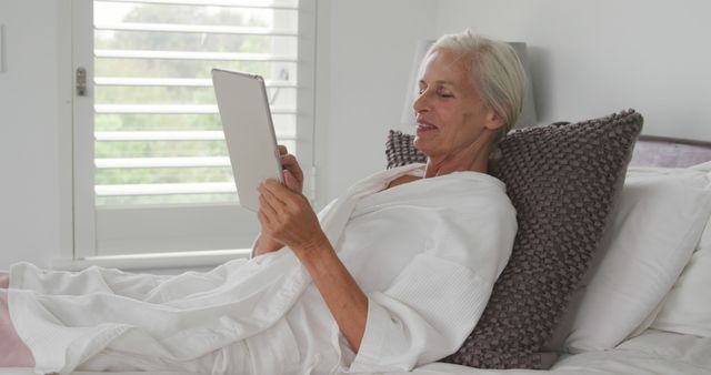 Senior Woman Relaxing in Bed Using Digital Tablet - Download Free Stock Images Pikwizard.com