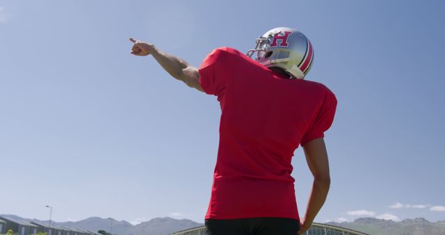 American Football Player Pointing While Wearing Helmet and Pad Outdoors - Download Free Stock Images Pikwizard.com