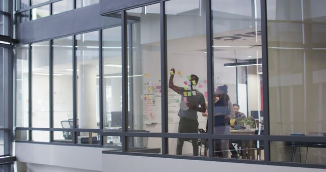 Group of Colleagues Brainstorming with Sticky Notes in Modern Office - Download Free Stock Images Pikwizard.com