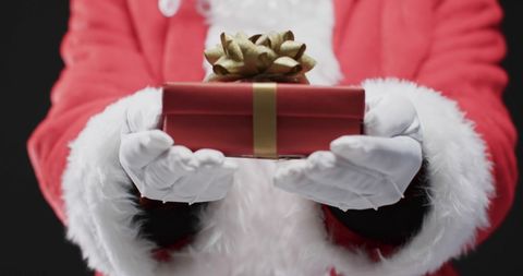 Santa Claus Presenting Christmas Gift with Copy Space