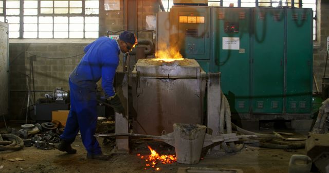 Worker in Blue Overall Operating Industrial Furnace Casting Mold - Download Free Stock Images Pikwizard.com