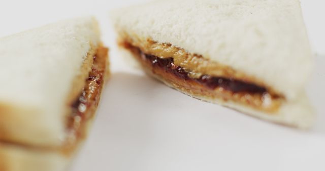 Image of peanut butter and jelly sandwich on a white surface. food, cuisine and catering ingredients.