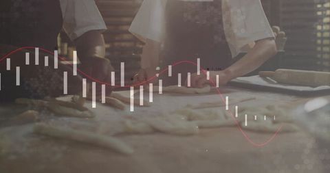 Artisan Bakers Shaping Dough with Financial Data Overlay