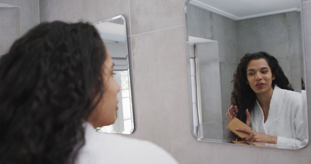 Woman with Curly Hair Preparing in Bathroom Mirror - Download Free Stock Images Pikwizard.com