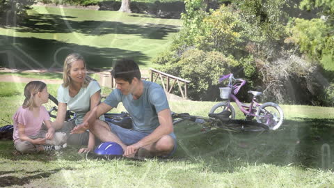Caucasian Family Enjoying Picnic in Park with Bikes