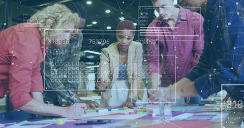 Multidisciplinary team collaborating over creative design plans with futuristic data overlays