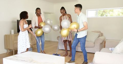 Friends Decorate Living Room with Balloons for Celebration