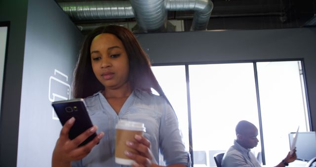 Focused Professional Woman Using Smartphone in Modern Office - Download Free Stock Images Pikwizard.com