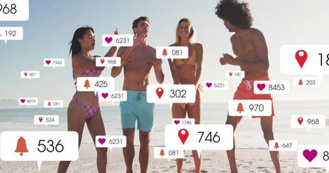 Group of Friends Engaging with Social Media on Beach
