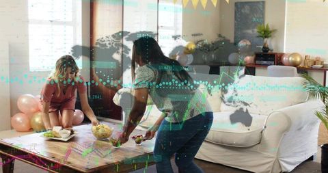 Friends arranging snacks for cozy living room party with balloons and digital data overlay
