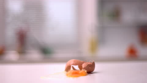 Egg Cracking Open on Counter with Splatter