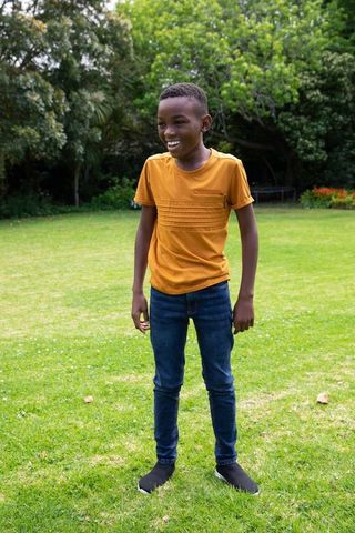 Smiling Young Boy Enjoying Day Outdoors in Vibrant Garden