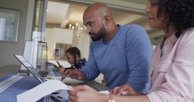 Ethnically Diverse Family Working Together at Home on Laptop and Paperwork - Download Free Stock Images Pikwizard.com