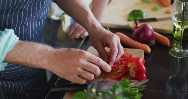 Close-up of chef slicing red bell pepper in a professional kitchen - Download Free Stock Images Pikwizard.com