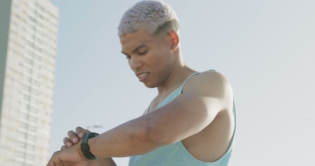 Fit young man checking smartwatch during outdoor exercise - Download Free Stock Images Pikwizard.com