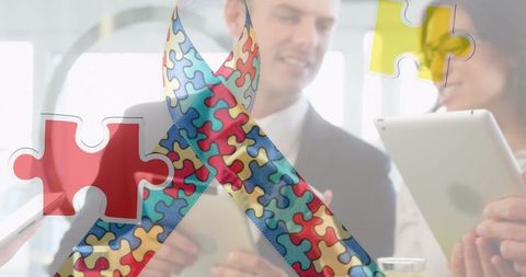 Autism awareness puzzle ribbon over professionals with digital devices