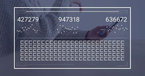 Tapping smartphone, checking hud data, wearing chunky grey knit sweater on pale wood table