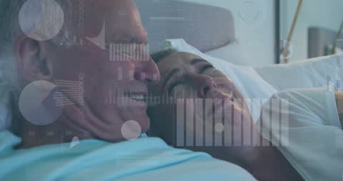 Smiling Senior Couple Relaxing with Data Overlay at Home