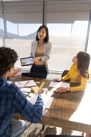 Diverse multiethnic team discussing business data in modern office