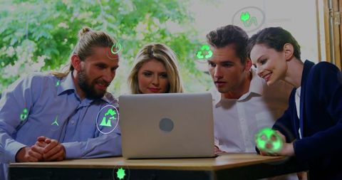 Collaborative team exploring green innovation on laptop with augmented eco icons