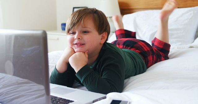 Happy Child Watching Cartoon on Laptop in Bedroom - Download Free Stock Images Pikwizard.com