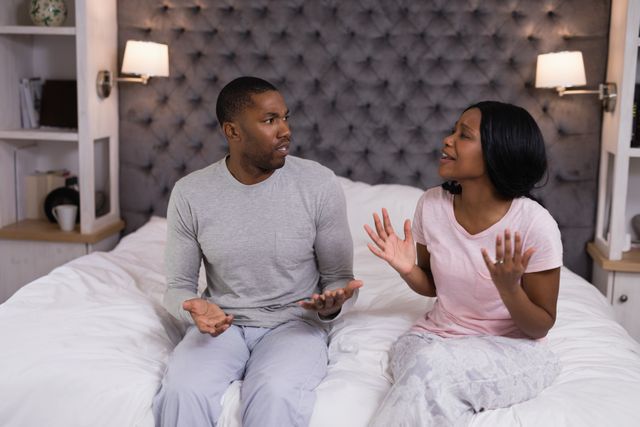 Young couple arguing in bedroom at home