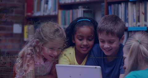 Elementary Students Collaborating on Tablet in School Library Learning Together