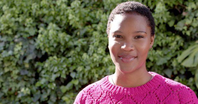 Smiling Woman in Pink Knitted Sweater with Greenery Background - Download Free Stock Images Pikwizard.com