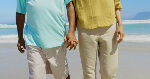 Senior African American Couple Holding Hands on Beach Walk