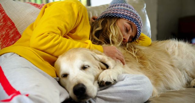 Young woman curling up and napping with her golden retriever on a cozy couch indoors. Great for themes of pet ownership, relaxation, cozy home moments, pet-human bond, and comfortable lifestyle.