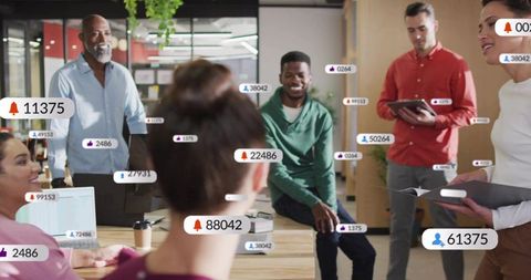 Coworkers collaborating in modern open-plan office with social media notification badges