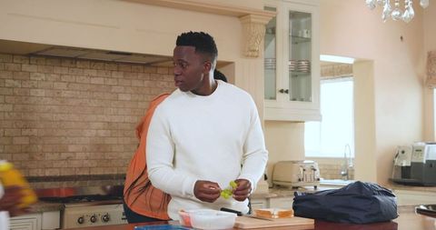 Father preparing school lunch in modern kitchen
