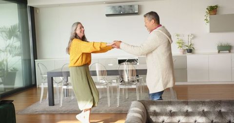 Senior Couple Dancing in Contemporary Living Room