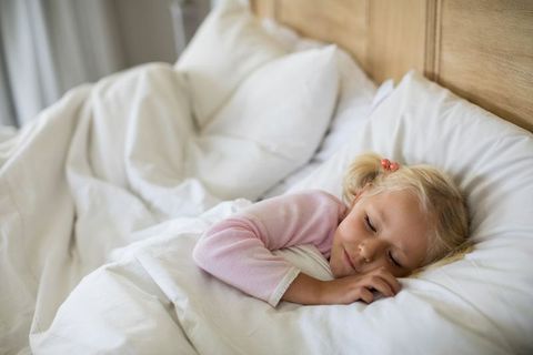 Peaceful Child Sleeping in Cozy Bed with Natural Light