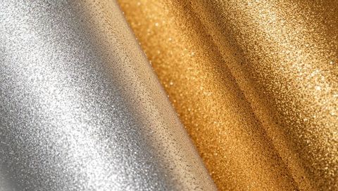 Silver and gold glitter fabric with diagonal folds luxury metallic sparkle background