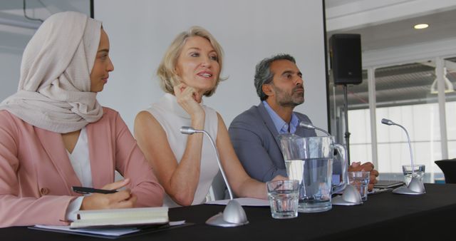 Diverse Professionals Listening at Business Conference With Microphones and Notebook - Download Free Stock Images Pikwizard.com