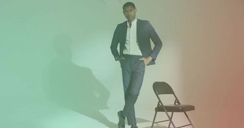 Stylish model in navy suit and colorful studio ambiance